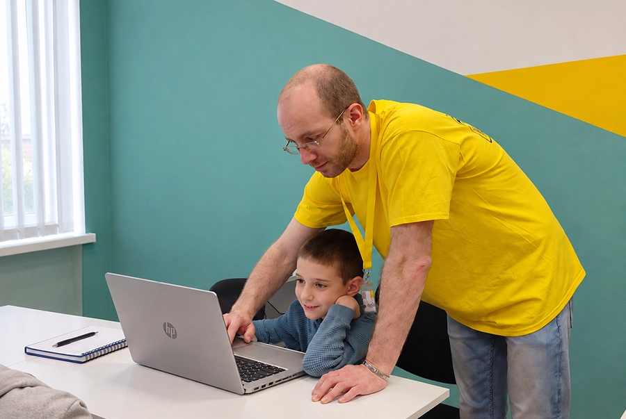 Преподавател помага индивидуално на дете по време на занятие по математика